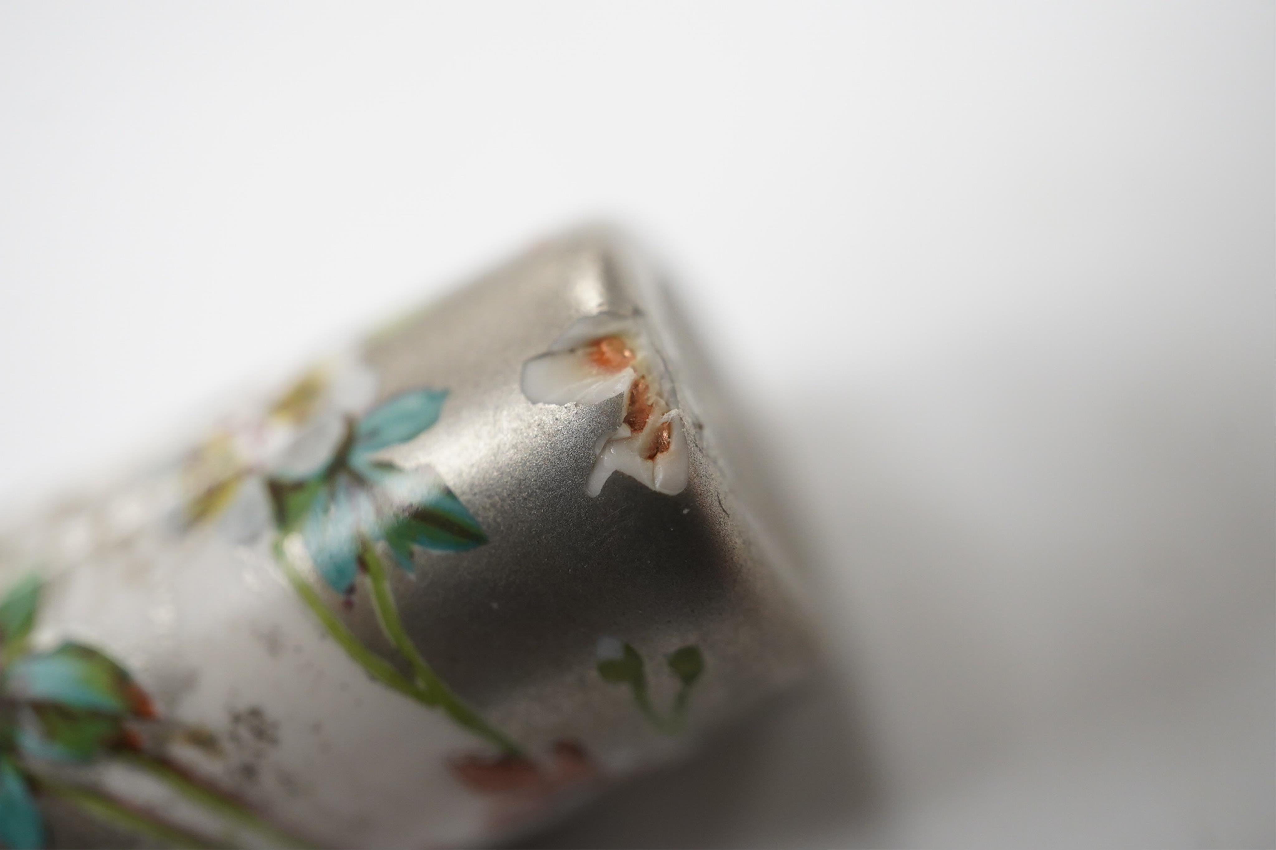 A Victorian white metal and enamel cylindrical scent bottle, 48mm (a.f.) and a late Victorian silver mounted willow pattern scent flask. Condition - poor to fair